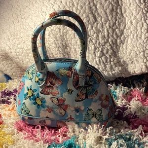 Blue butterfly purse with comfortable handle and golden zipper